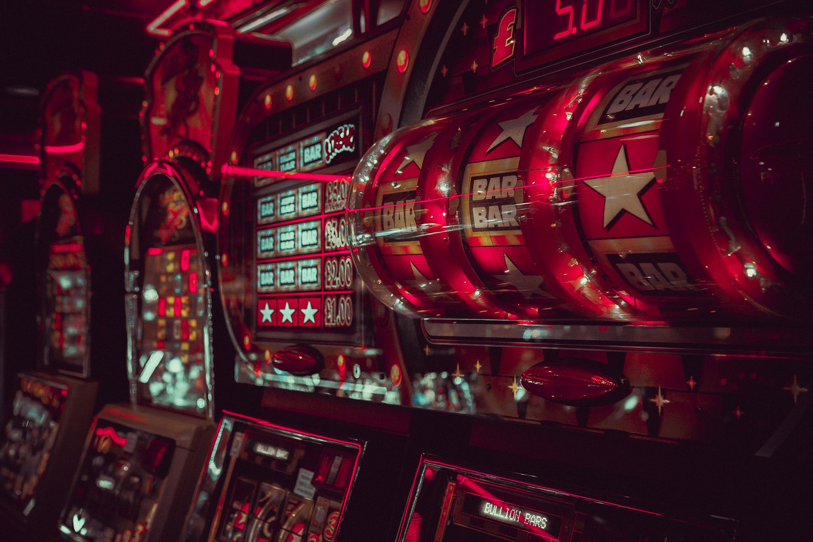Close-up of slot machine reels lit in red