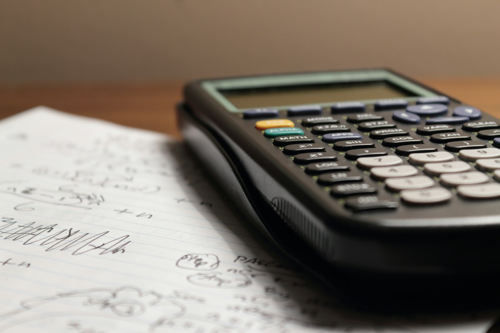 A calculator resting on handwritten notes